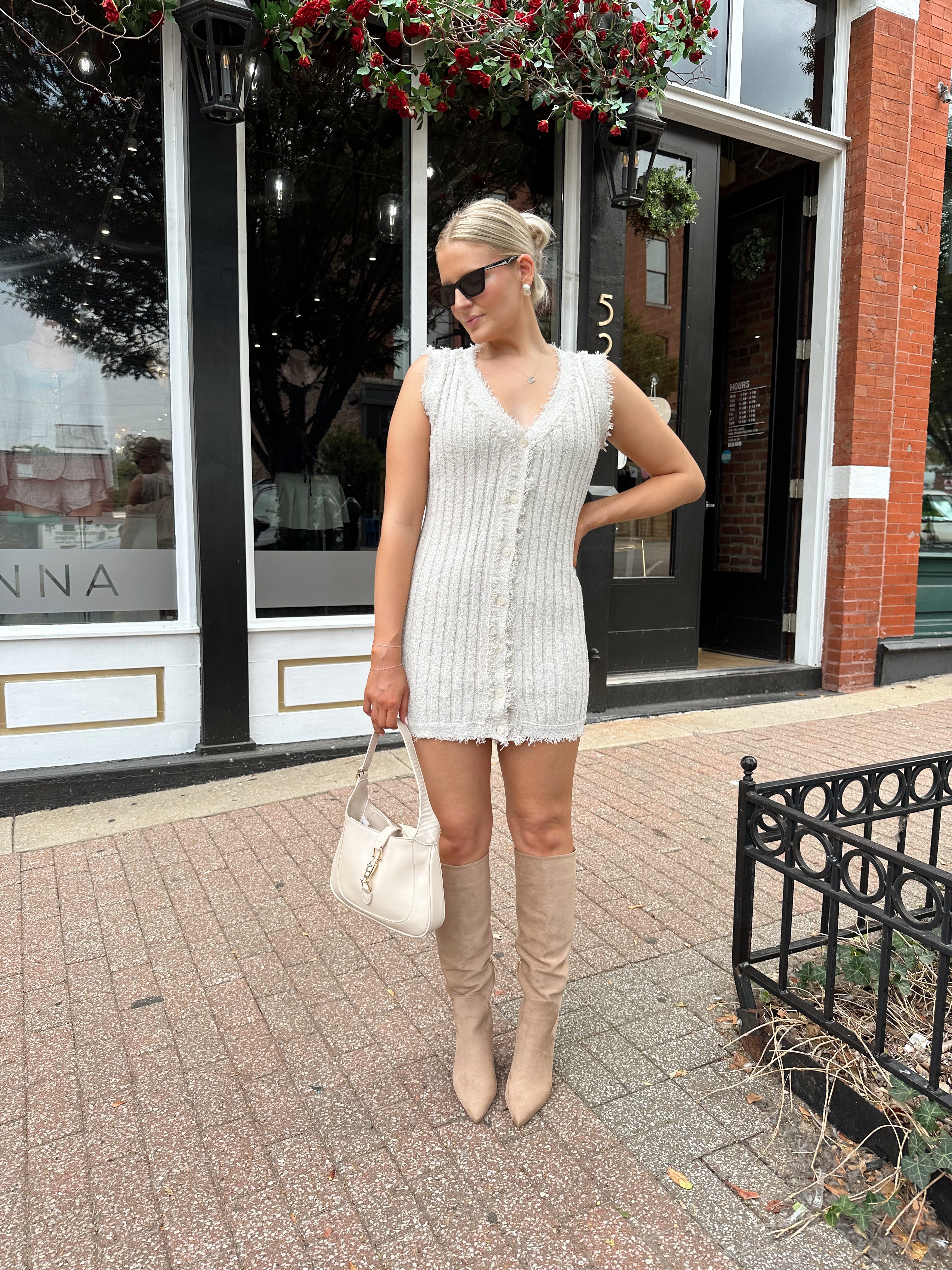 Beige sweater mini dress with fringe trim and front button closure