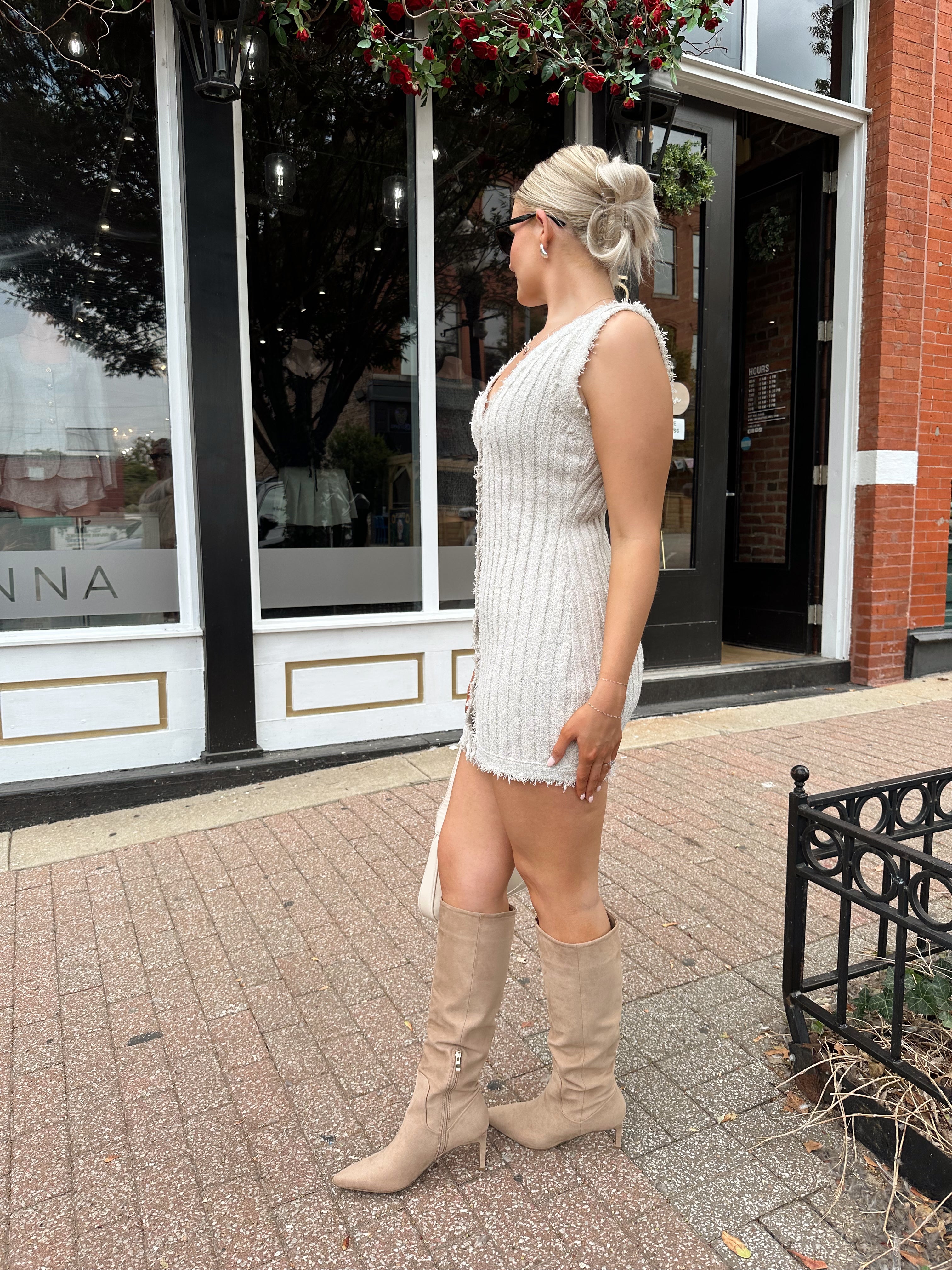 Beige sweater mini dress with fringe trim and front button closure