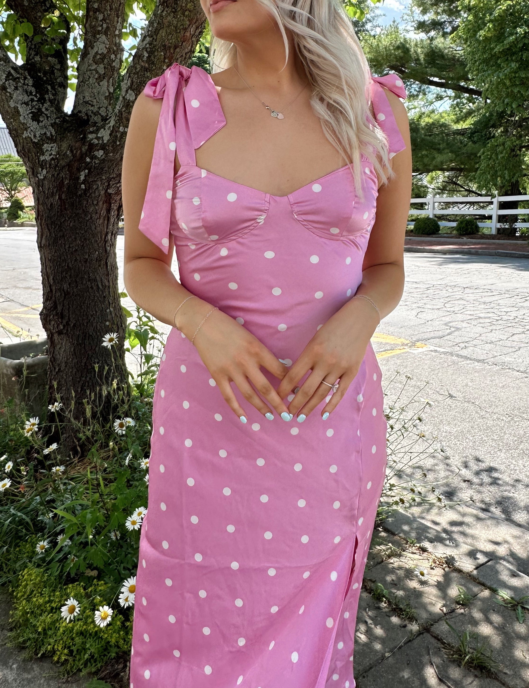 Pink satin midi dress with white polka dots and self tie straps and a slit.