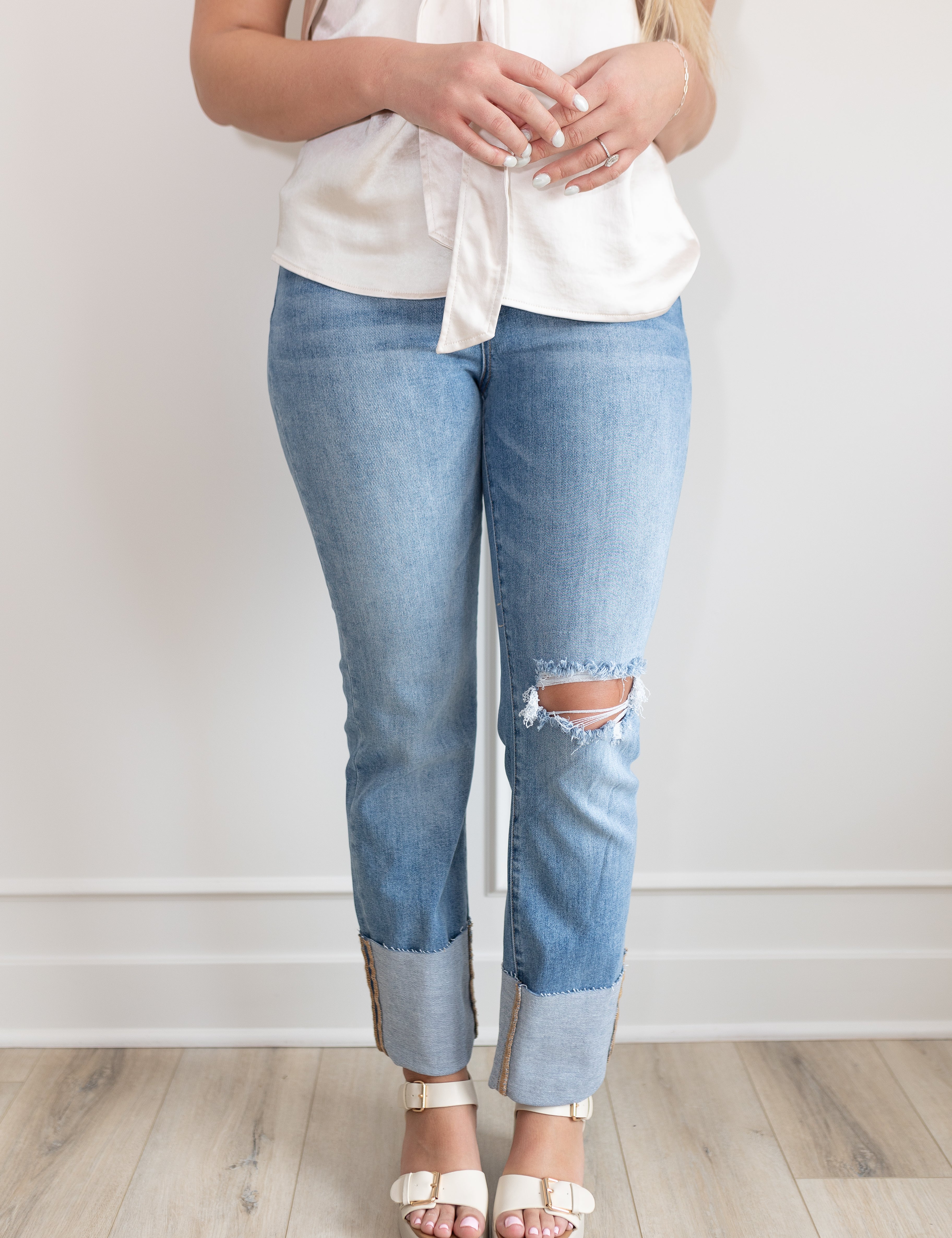 High waisted medium wash straight leg Jean with wide cuff. 