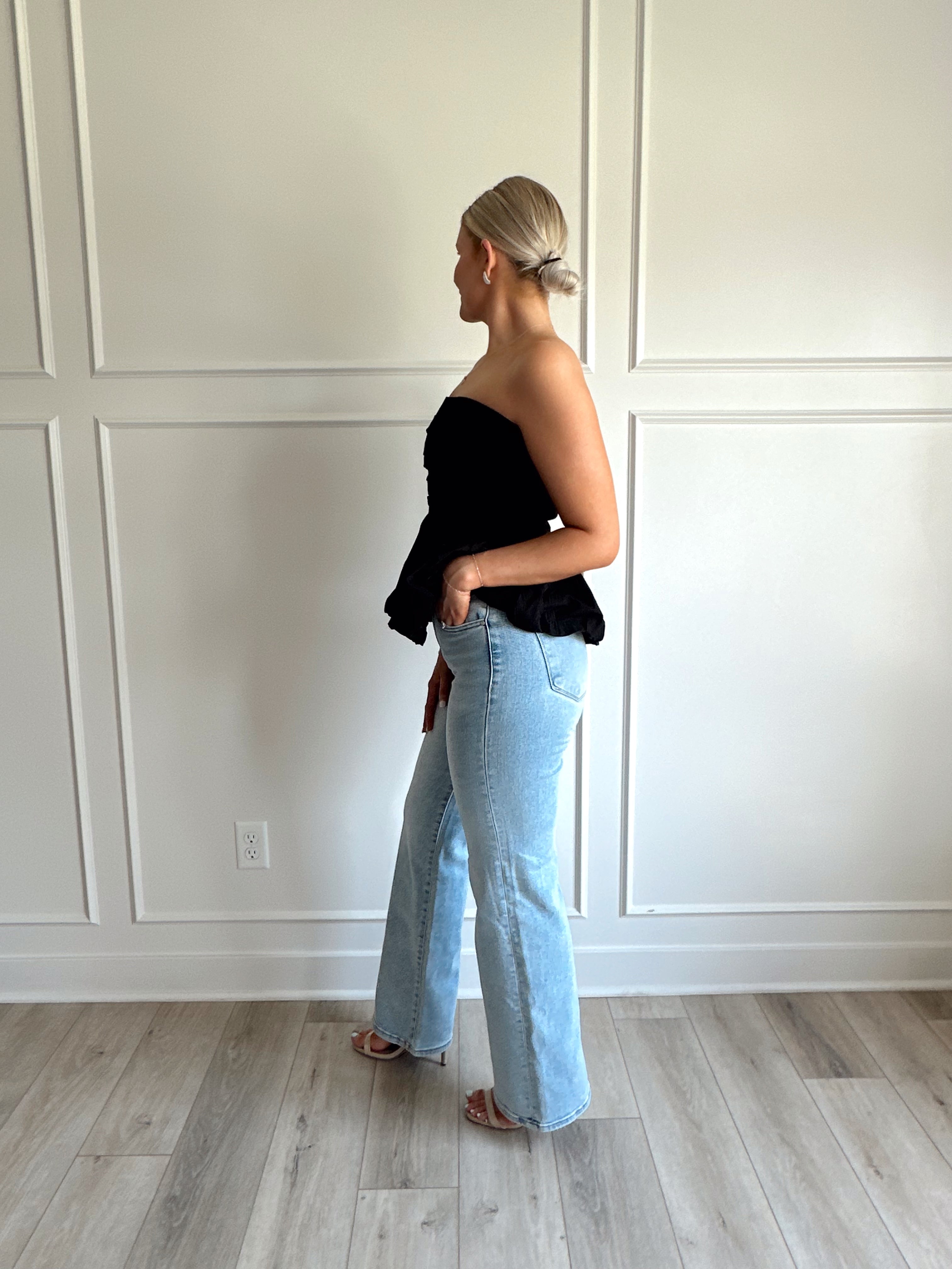 Black strapless peplum top with bubble hem.
