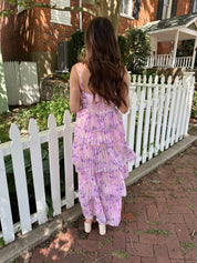 Pink pleated tiered maxi dress with a lavender floral pattern.