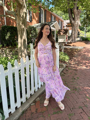 Pink pleated tiered maxi dress with a lavender floral pattern.