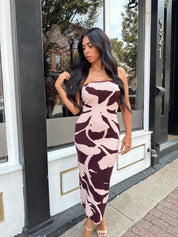 Woman wearing burgundy pattern strapless bodycon midi dress.