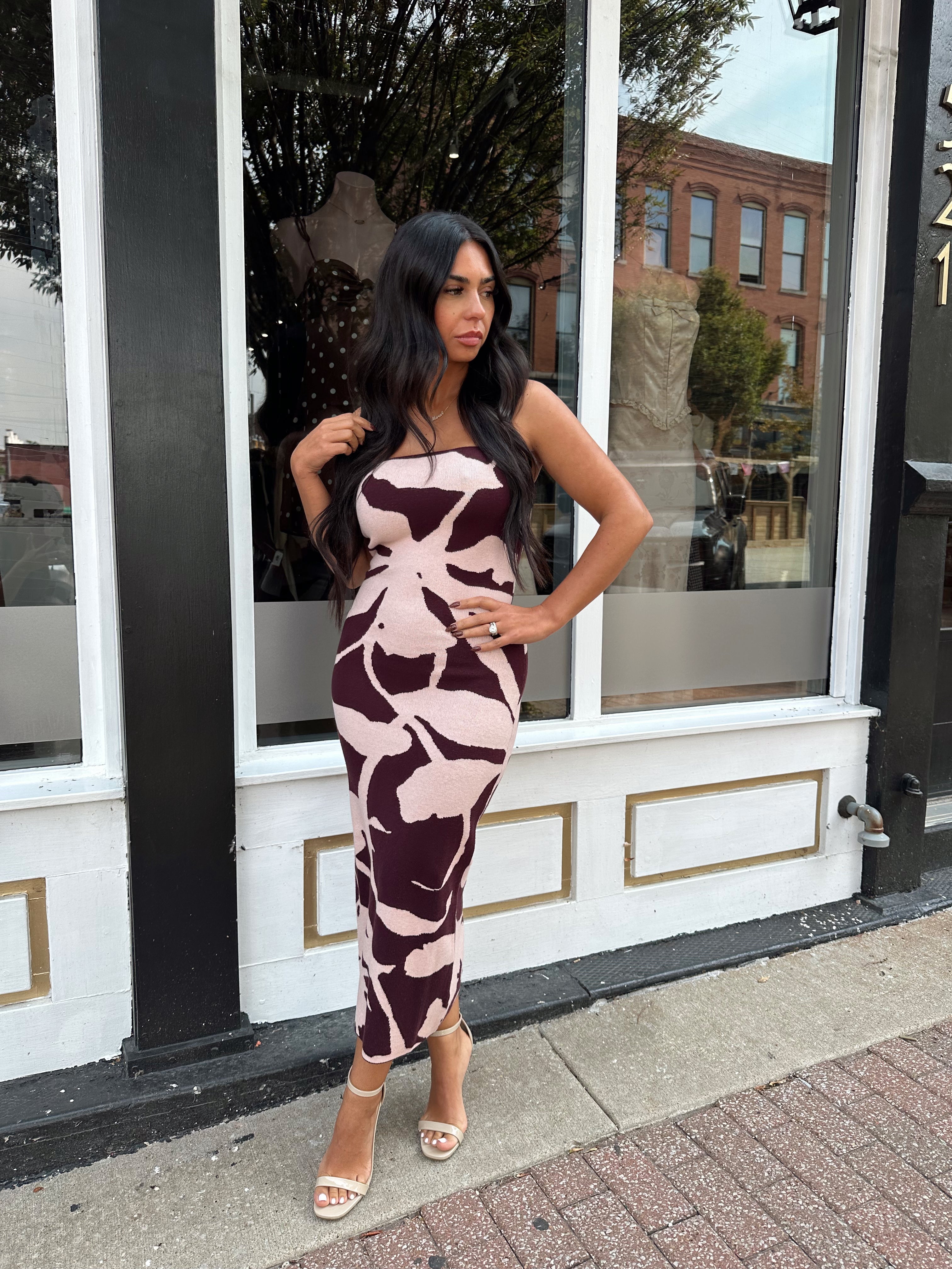 Woman wearing burgundy pattern strapless bodycon midi dress.
