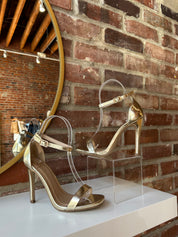 Gold metallic open toe heel with slim ankle strap and sleek stiletto heel