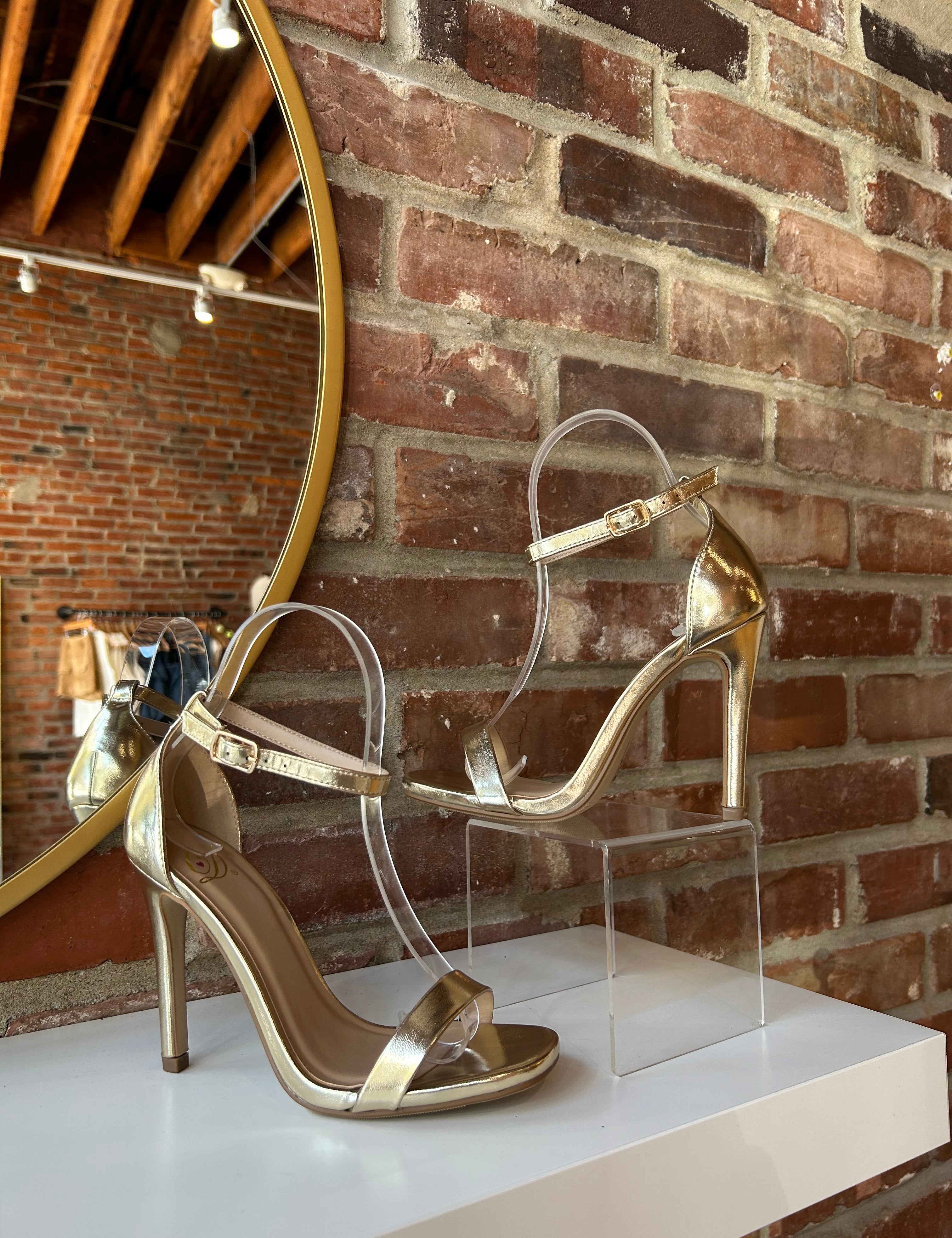 Gold metallic open toe heel with slim ankle strap and sleek stiletto heel