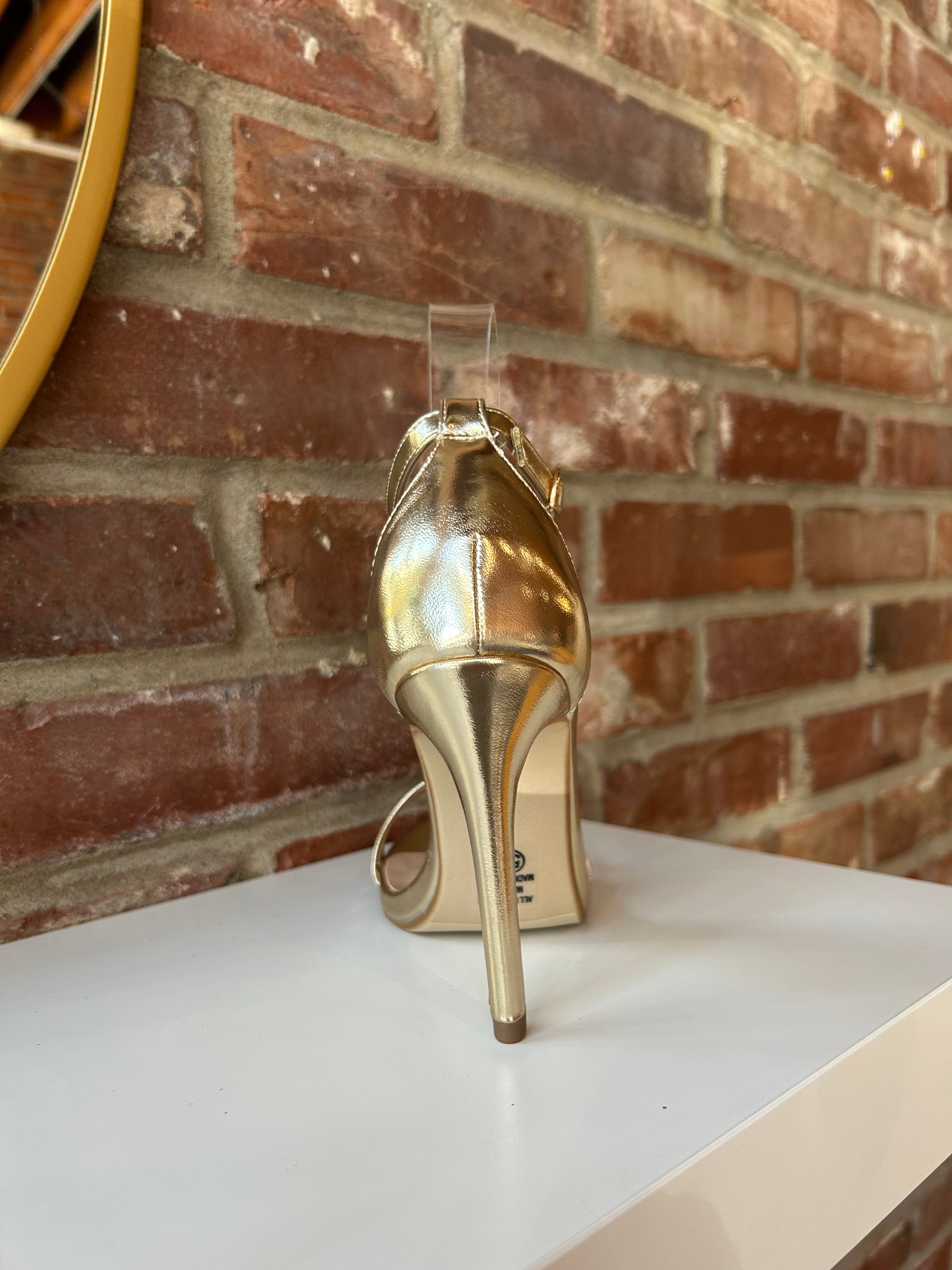 Gold metallic open toe heel with slim ankle strap and sleek stiletto heel