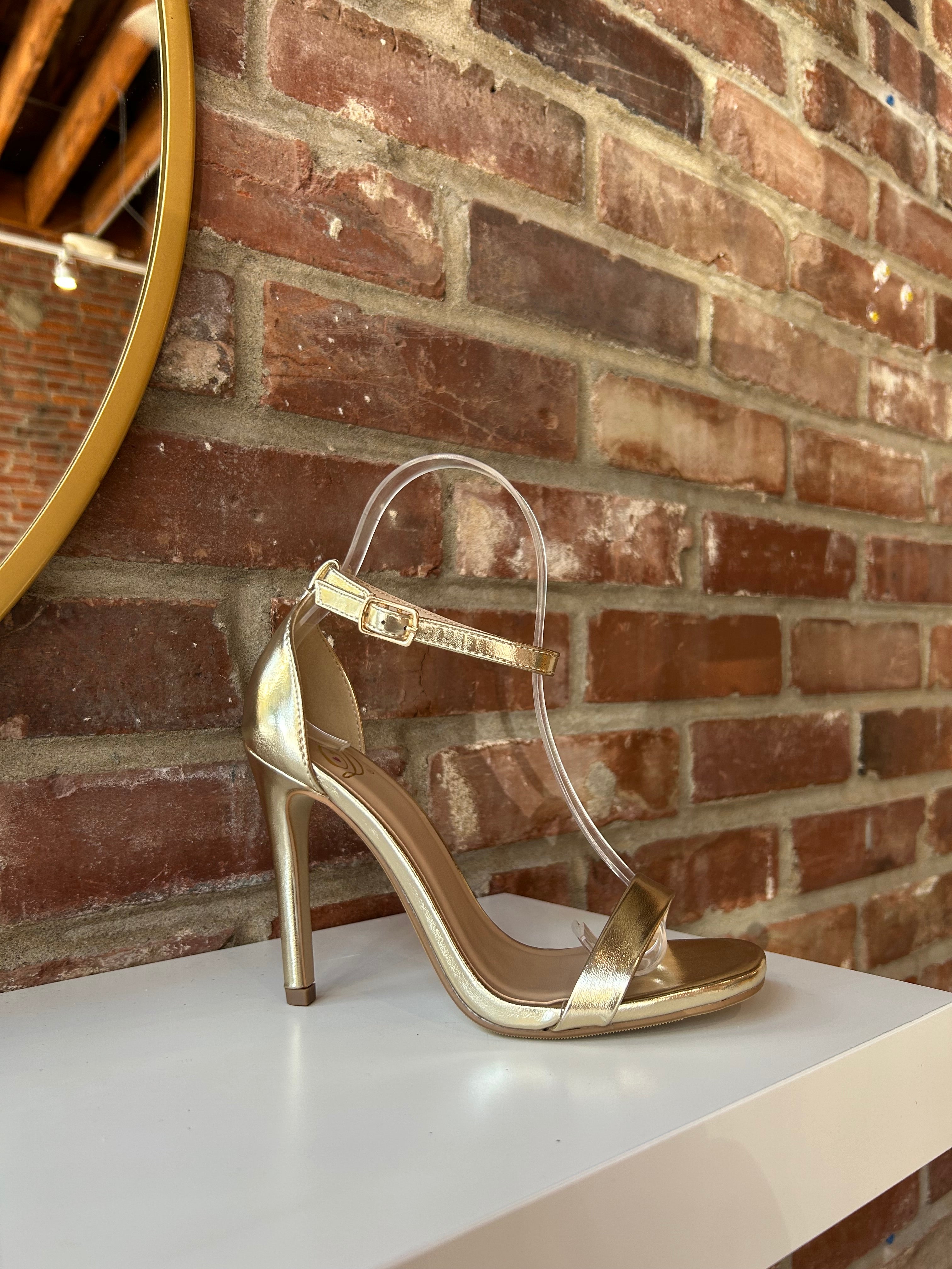 Gold metallic open toe heel with slim ankle strap and sleek stiletto heel