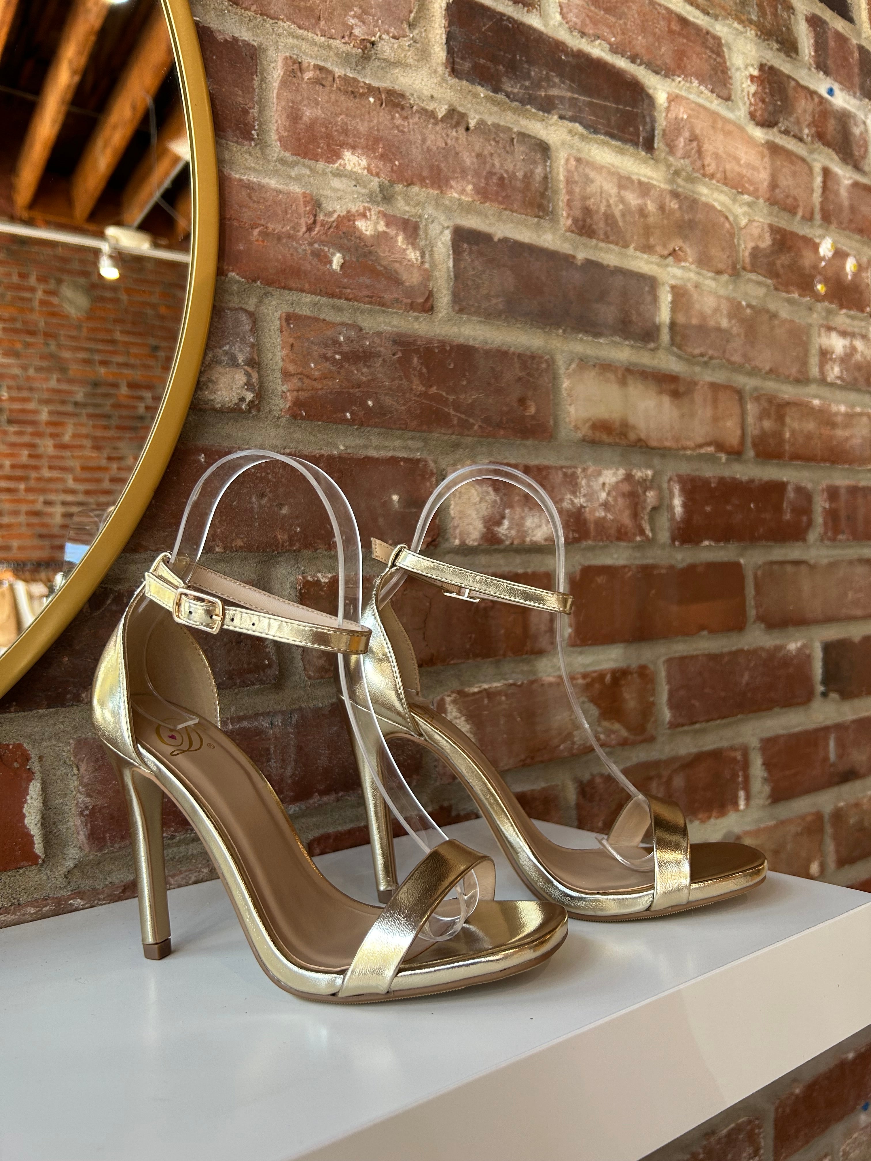Gold metallic open toe heel with slim ankle strap and sleek stiletto heel