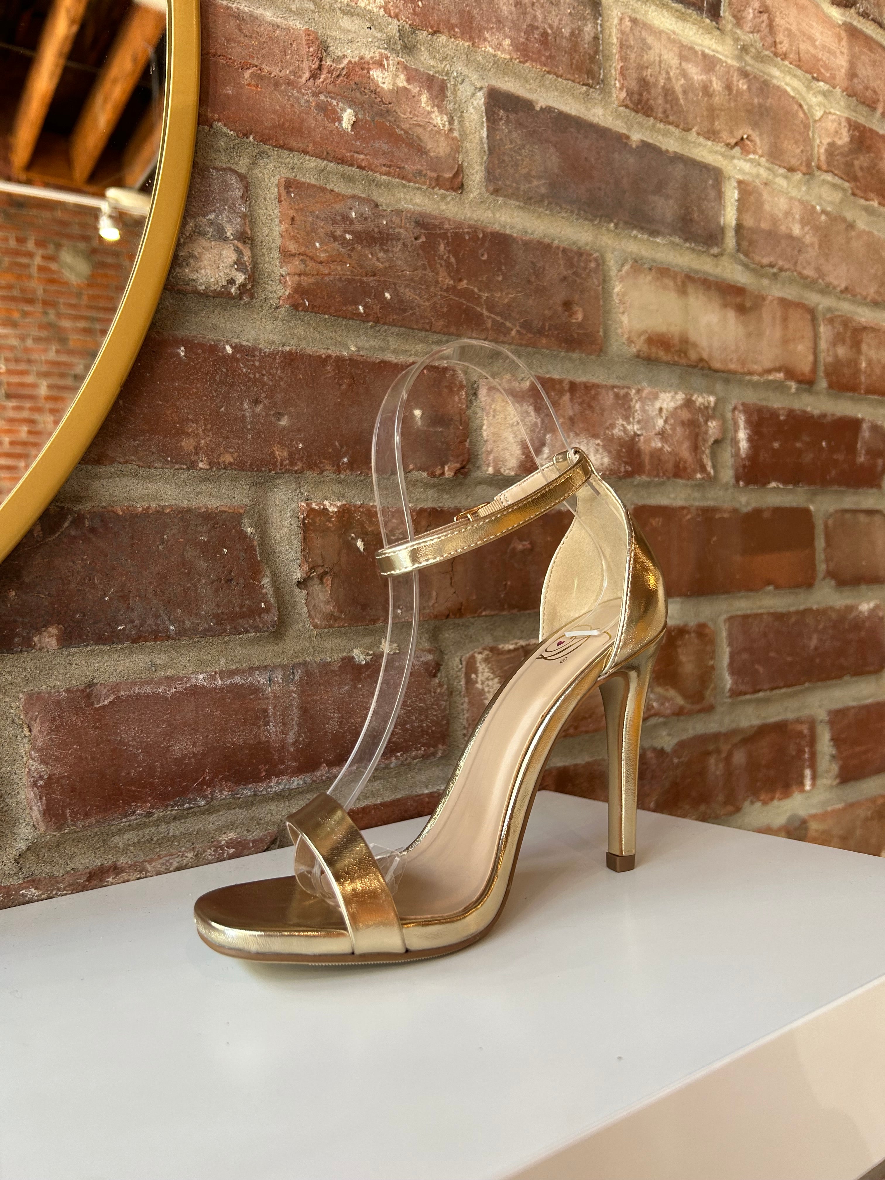 Gold metallic open toe heel with slim ankle strap and sleek stiletto heel