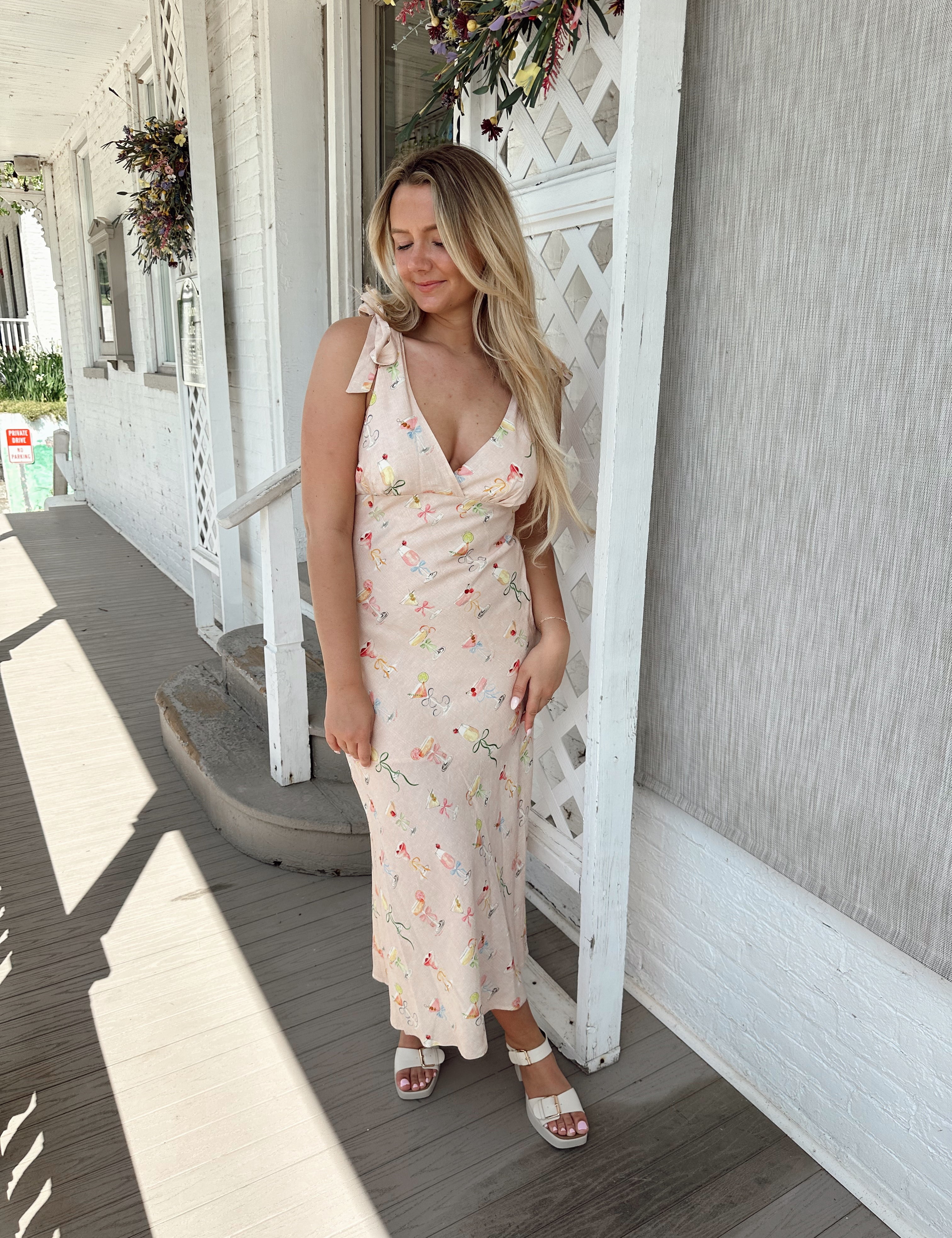Pink midi dress with martini pattern. V-neckline with self tie straps.