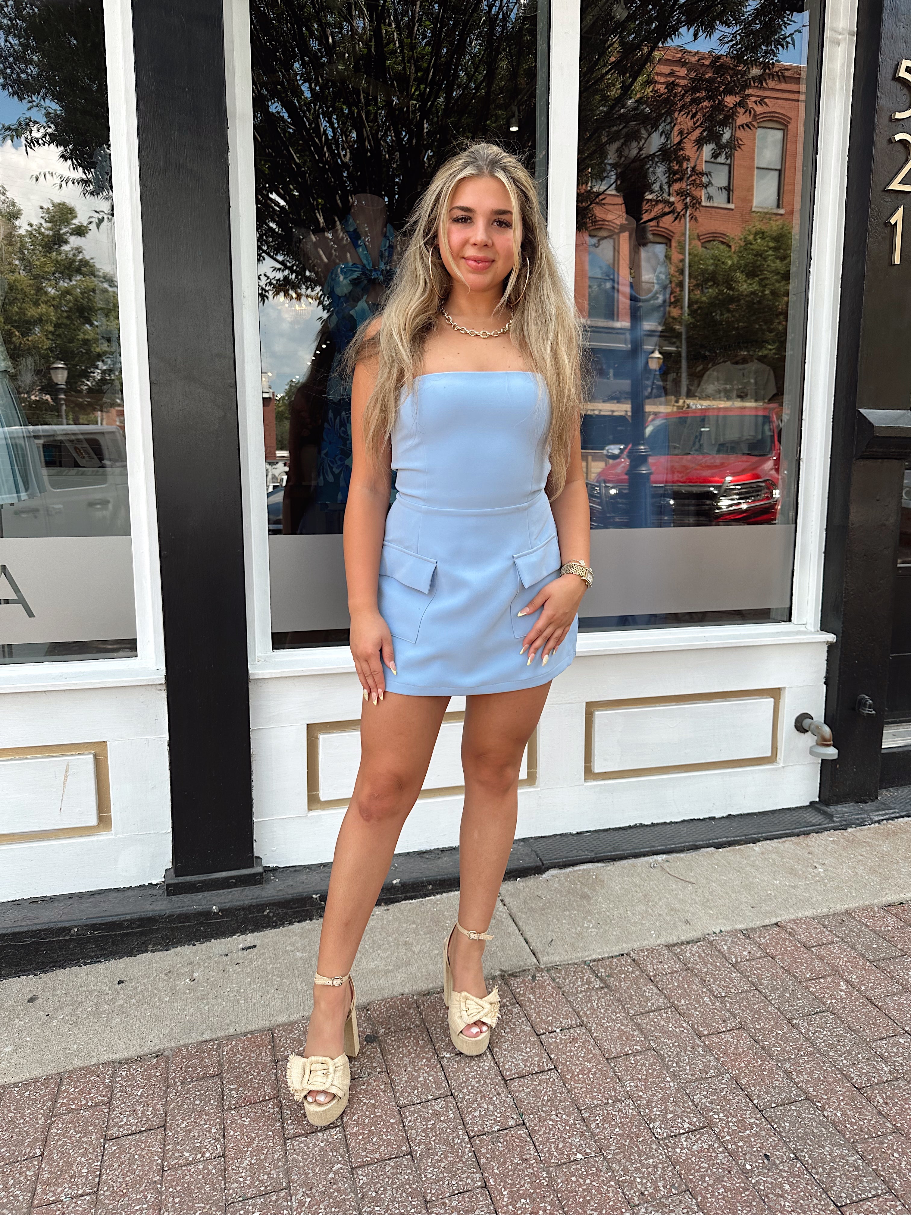 Sky blue tailored strapless mini dress with built in shorts and faux pockets.