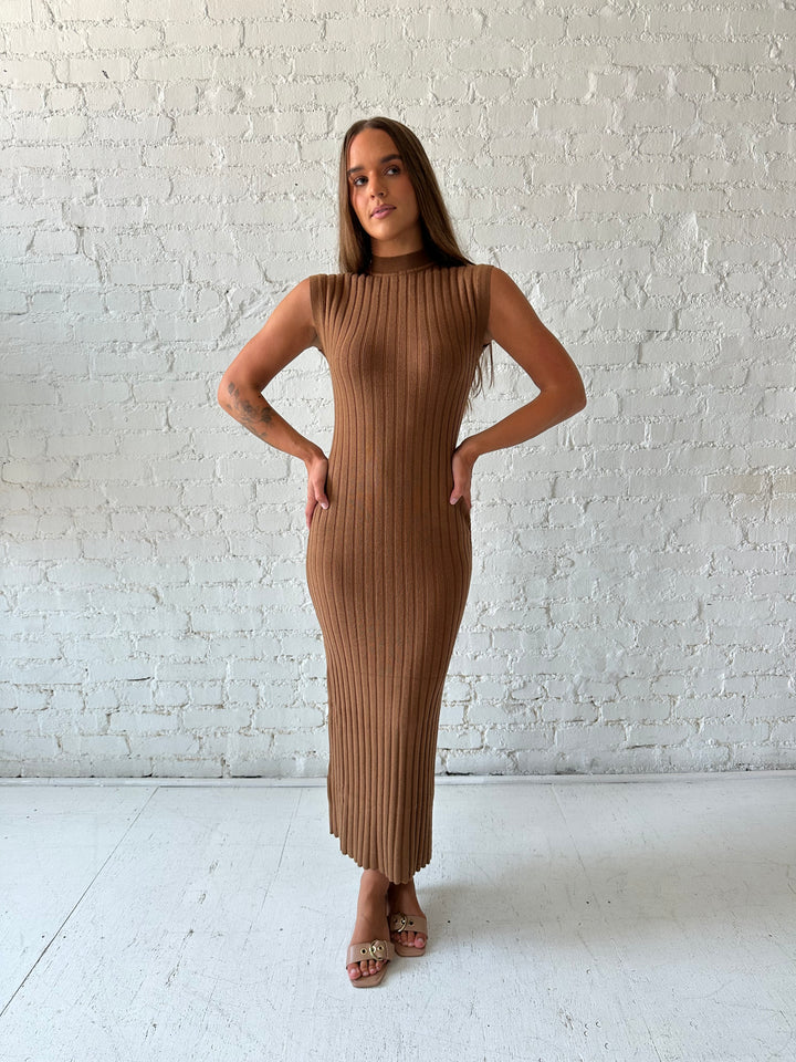 Woman wearing brown knit midi dress with high neckline.