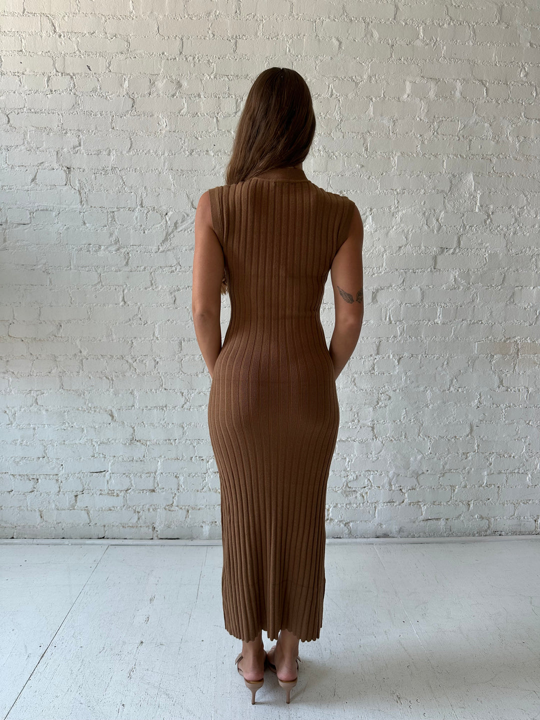 Woman wearing brown knit midi dress with high neckline.
