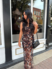 Woman wearing black multi color floral mesh bodycon maxi dress. 