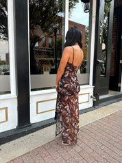 Woman wearing black multi color floral mesh bodycon maxi dress. 