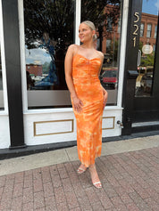 Orange floral mesh maxi dress with criss-cross back.