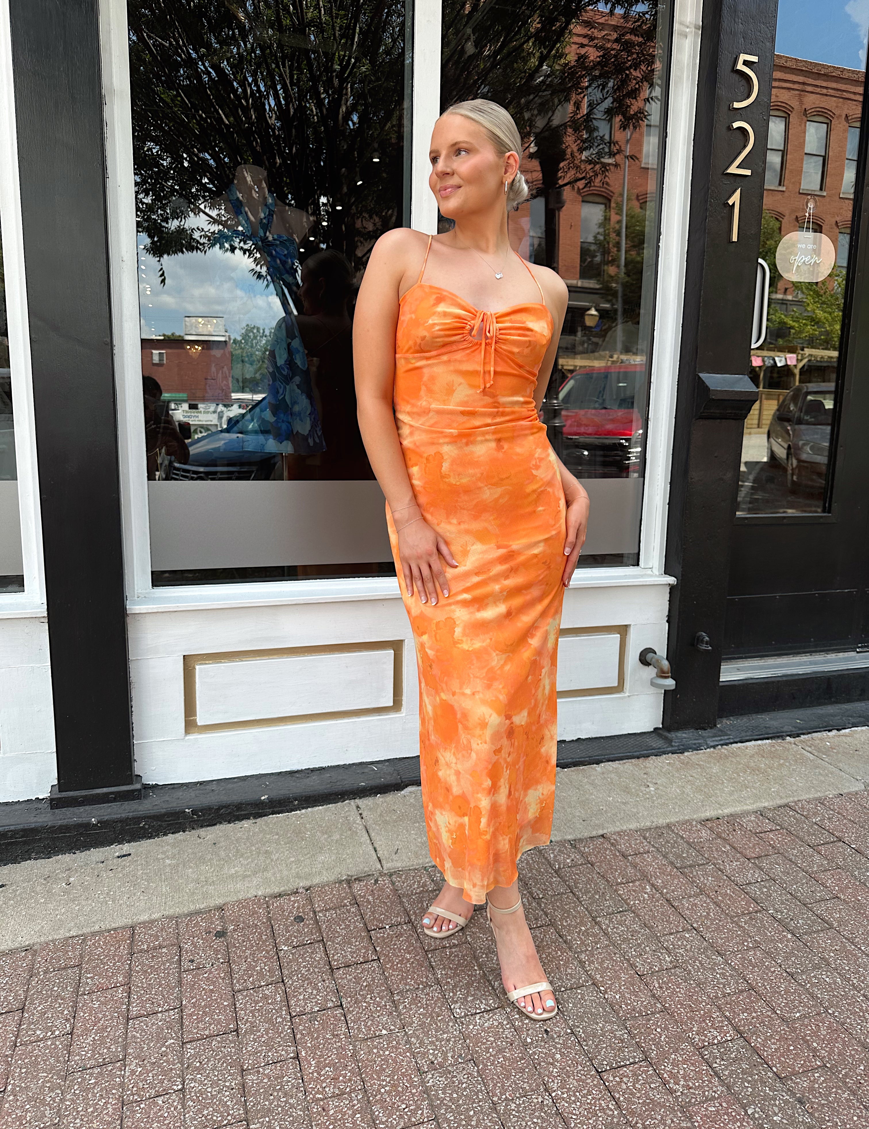 Orange floral mesh maxi dress with criss-cross back.