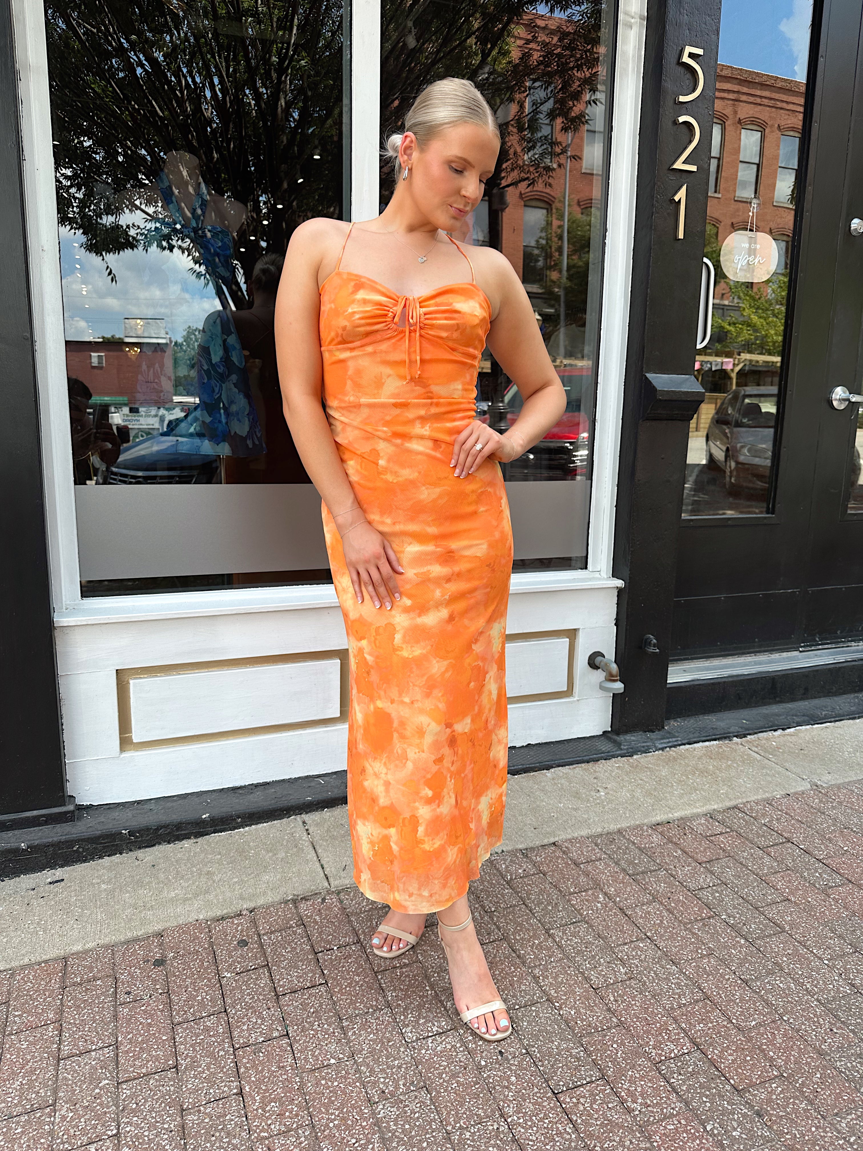 Orange floral mesh maxi dress with criss-cross back.