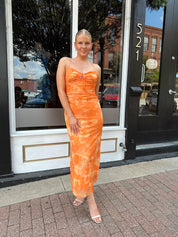 Orange floral mesh maxi dress with criss-cross back.