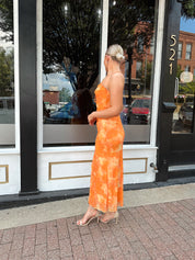 Orange floral mesh maxi dress with criss-cross back.