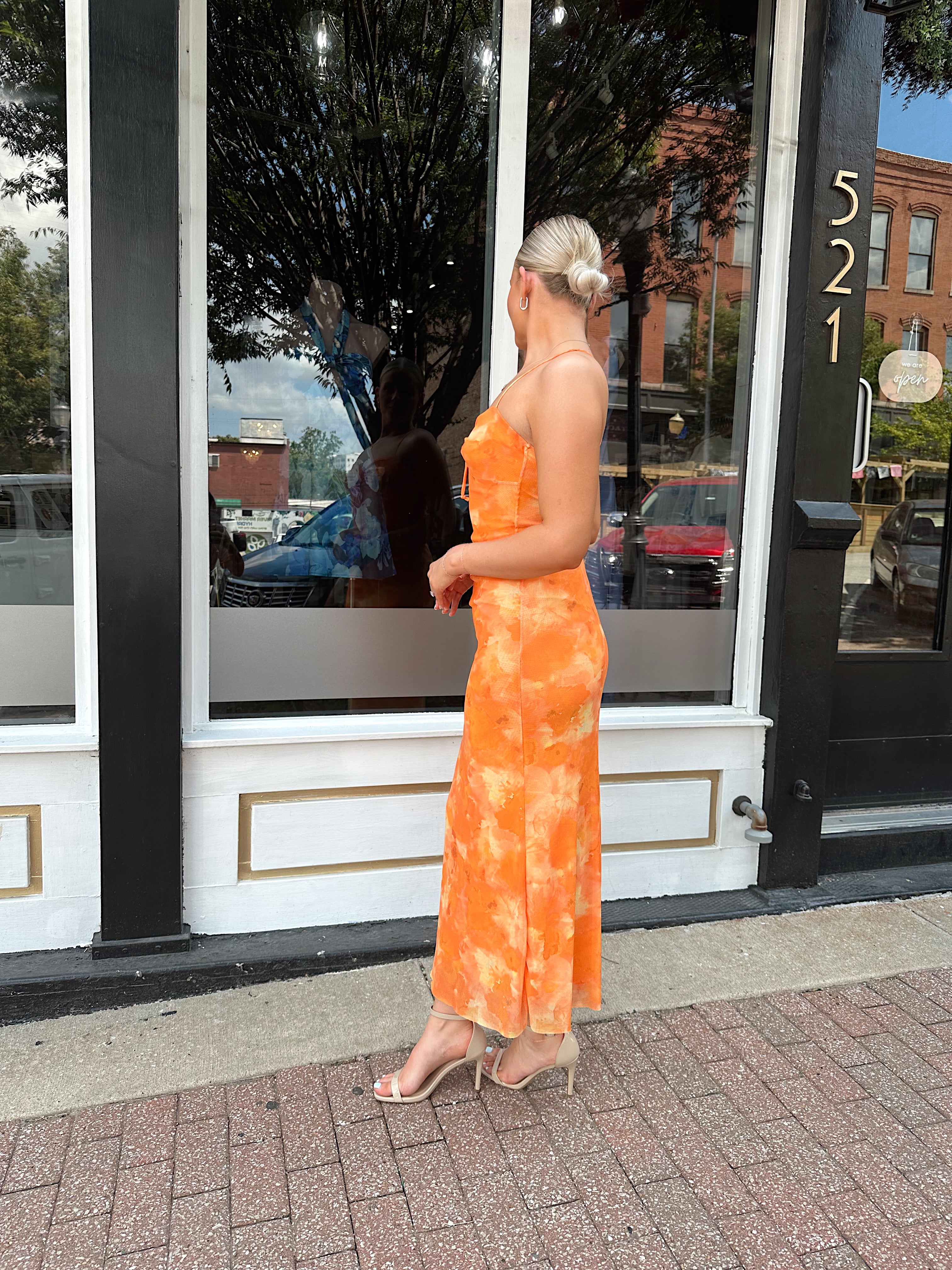 Orange floral mesh maxi dress with criss-cross back.