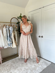 Champagne embroidered floral midi dress with ruffles, side cutouts, and lace-up open back