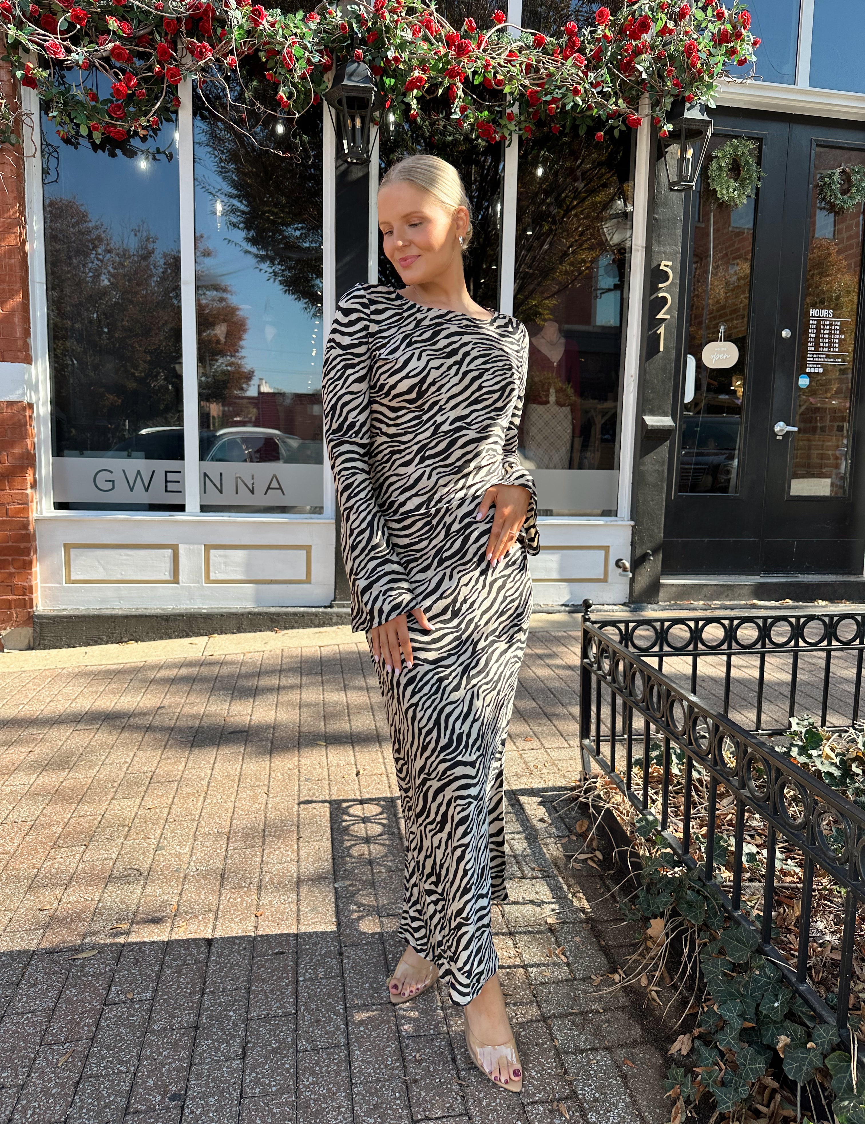 Woman wearing long sleeve zebra print maxi dress with wide sleeve.
