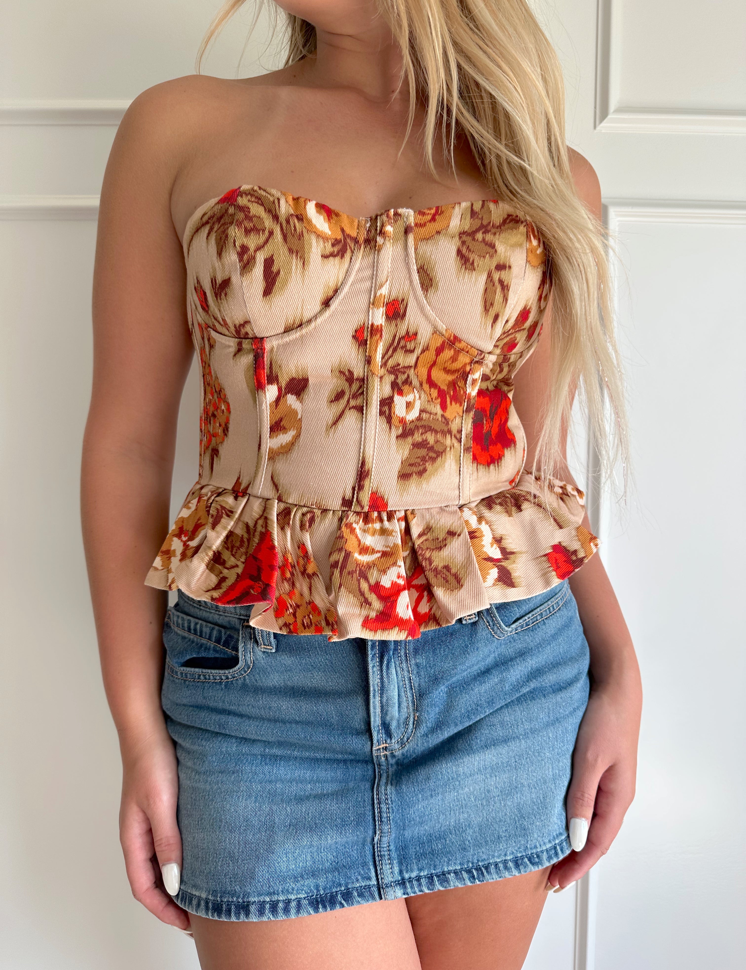 Orange and brown floral strapless peplum top.