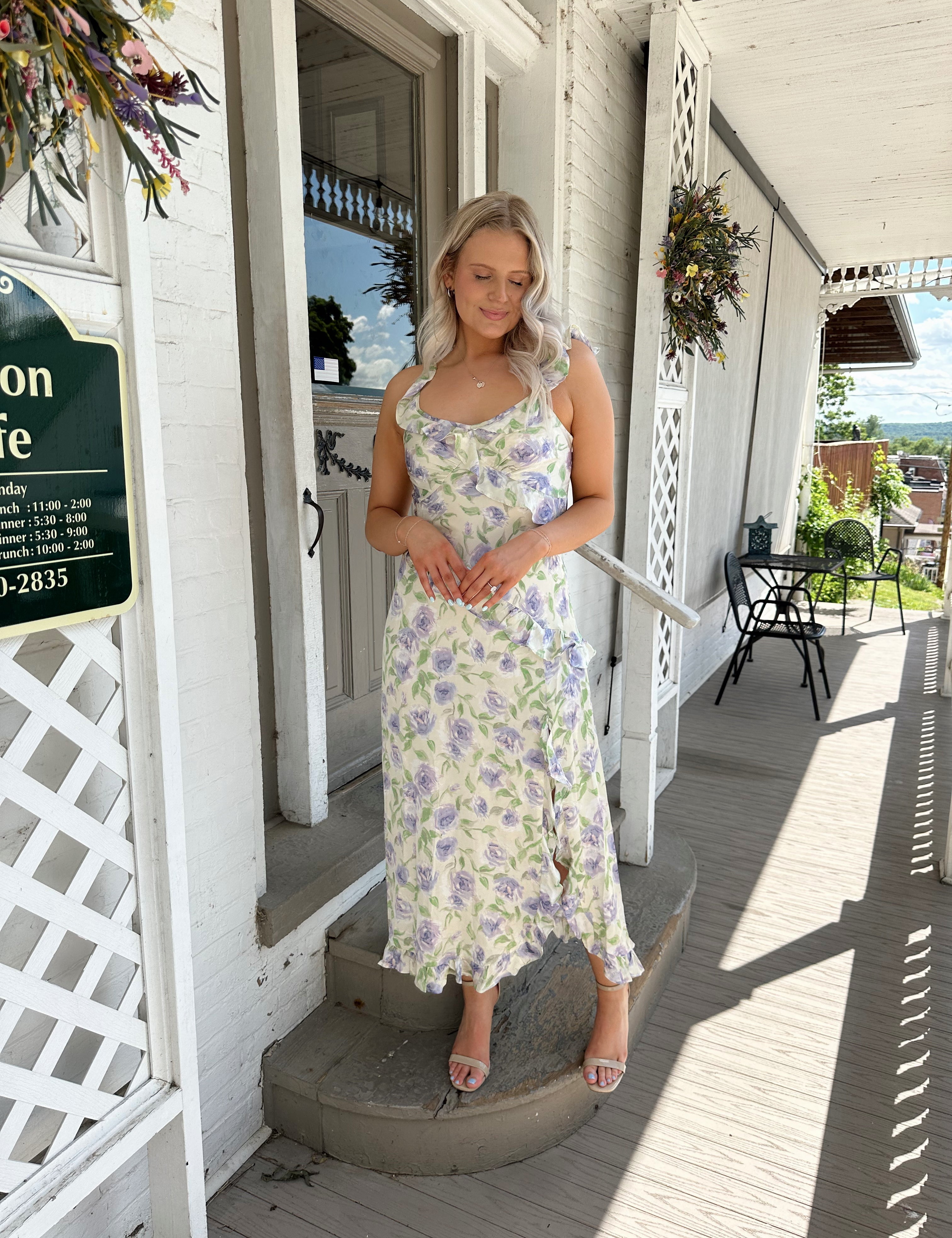 Cream satin dress with lavender floral pattern with ruffle detail.