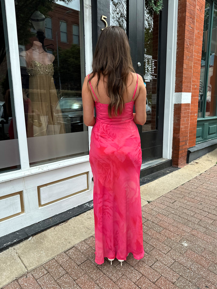 Woman wearing hot pink floral maxi dress with adjustable spaghetti straps and bustier bodice. 