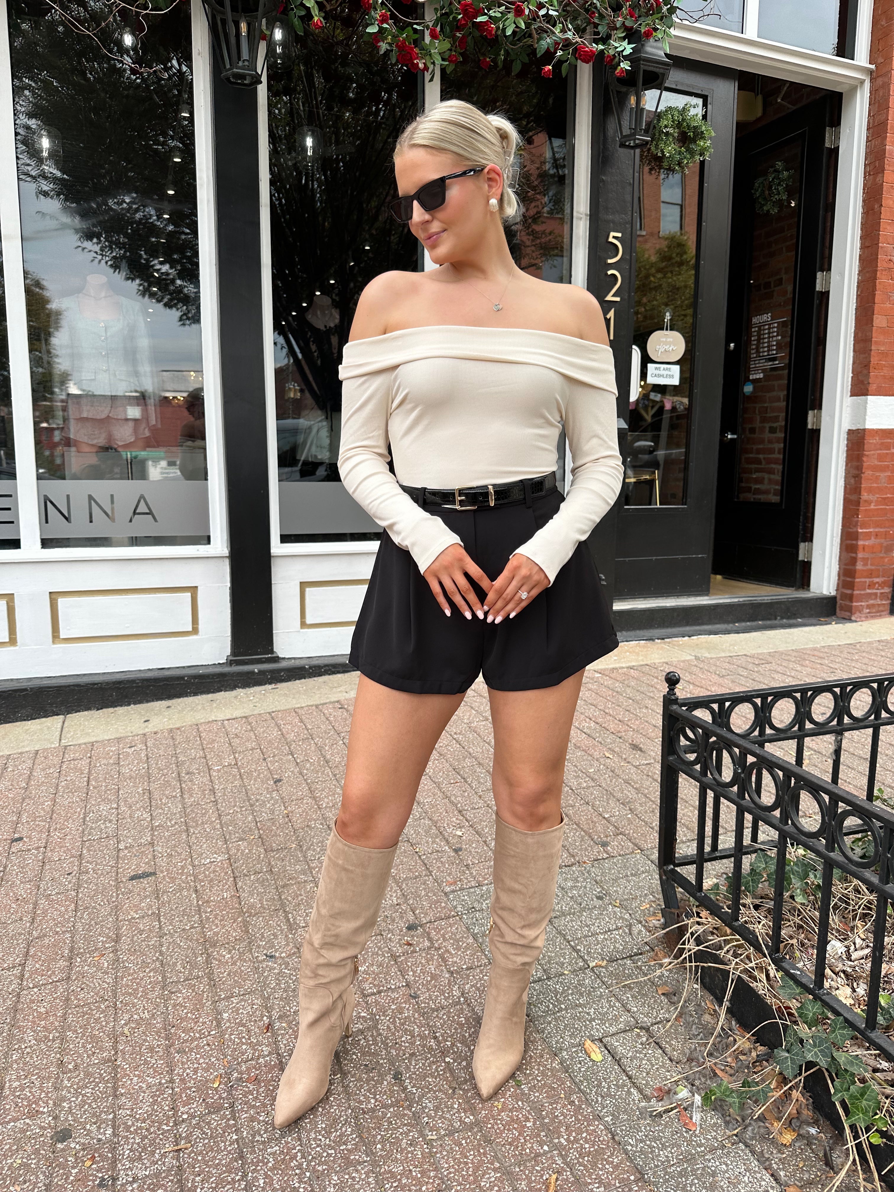Black tailored short with functional pockets and sleek structured silhouette