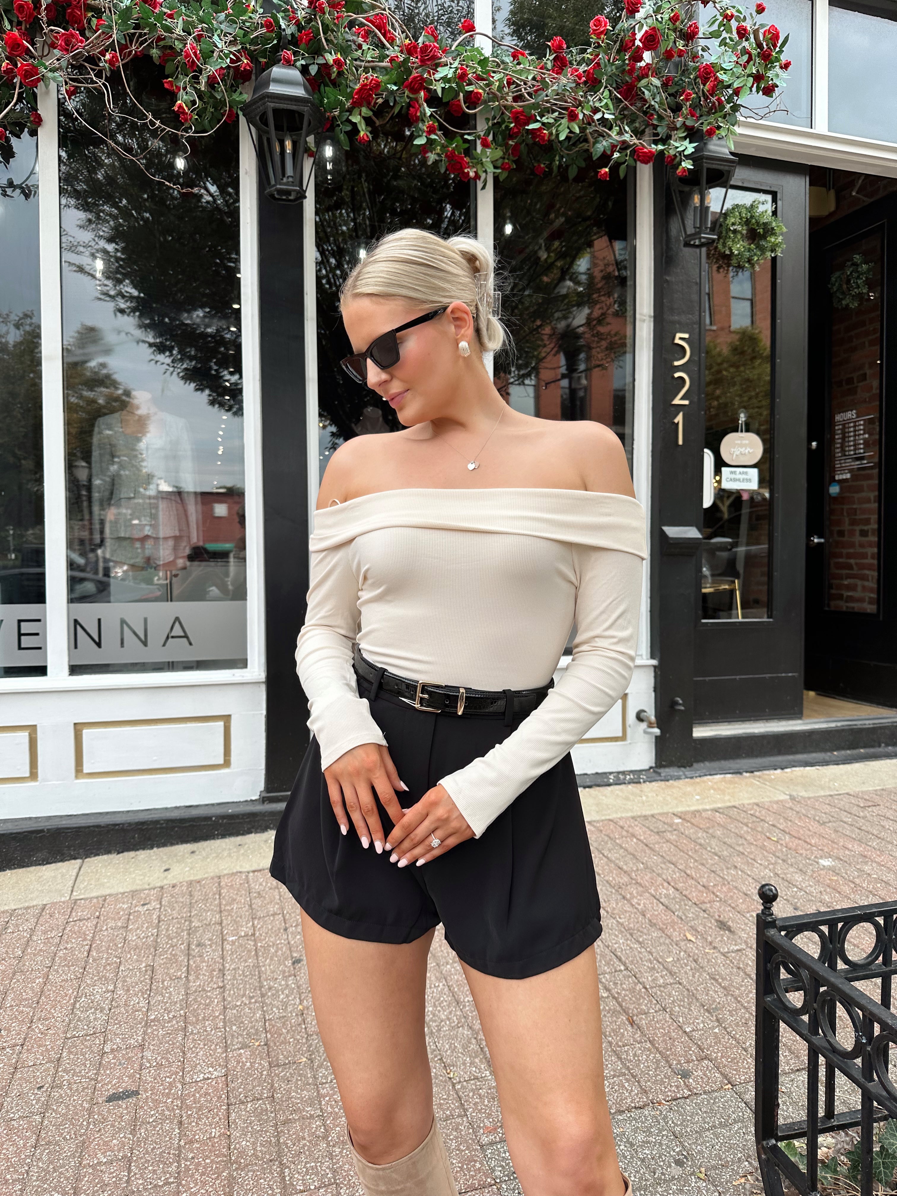 Black tailored short with functional pockets and sleek structured silhouette