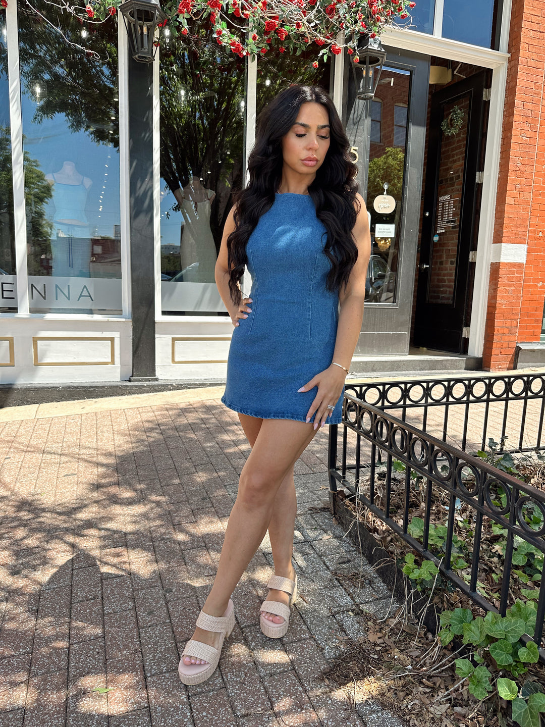 Woman wearing medium wash denim mini dress.