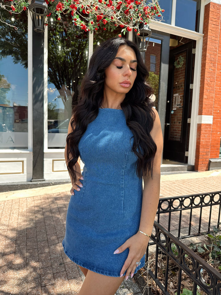 Woman wearing medium wash denim mini dress.