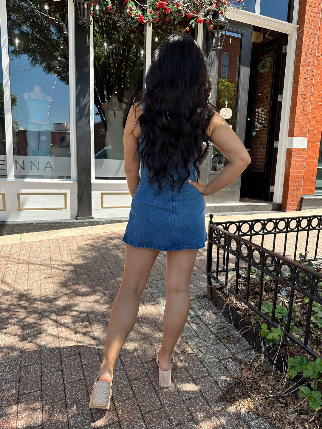 Woman wearing medium wash denim mini dress.