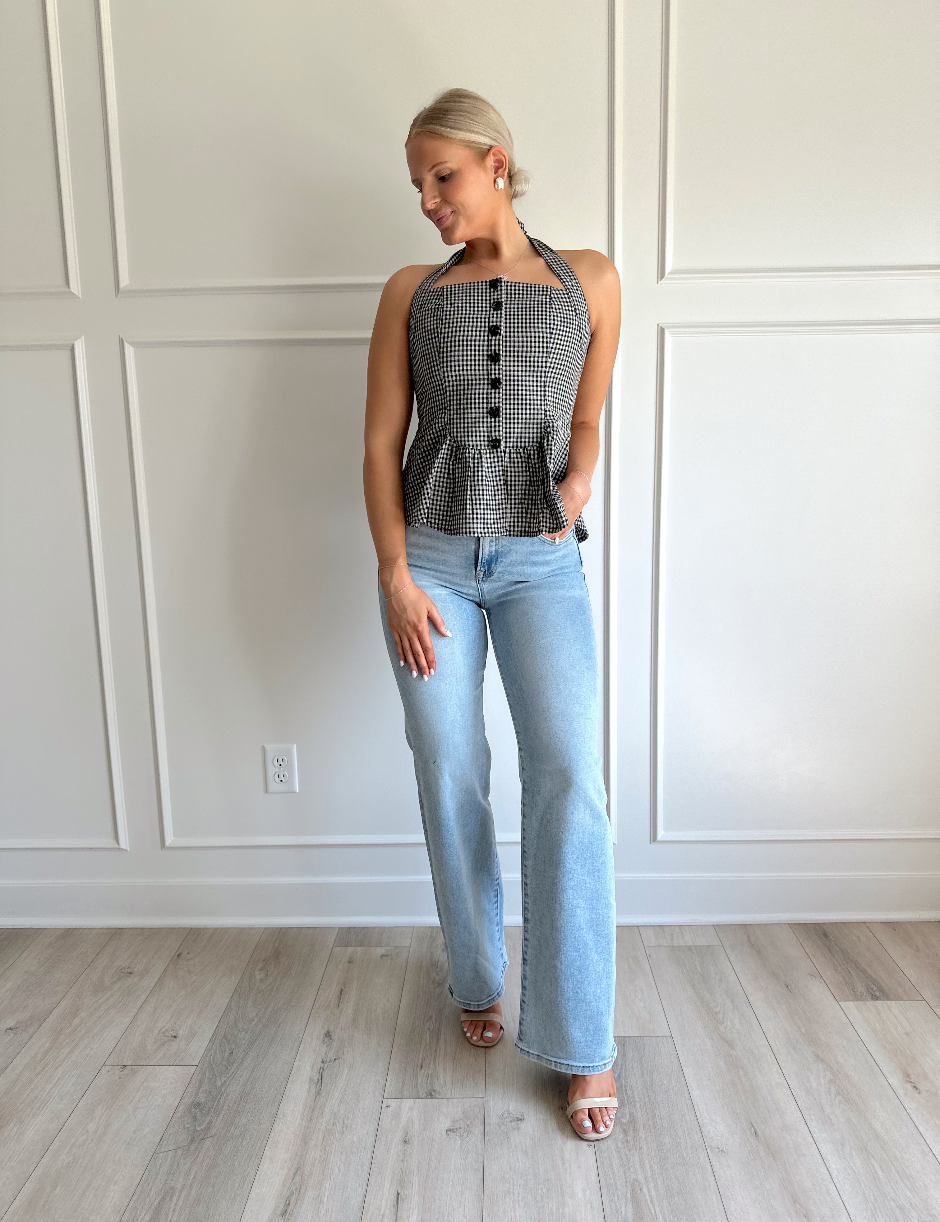 Black and white checkered top with halter neck and button detailing.
