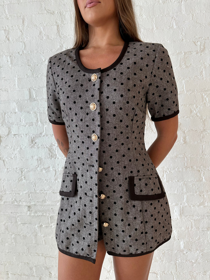 Woman wearing mocha textured polka dot two piece tailored set with an kitten heels.
