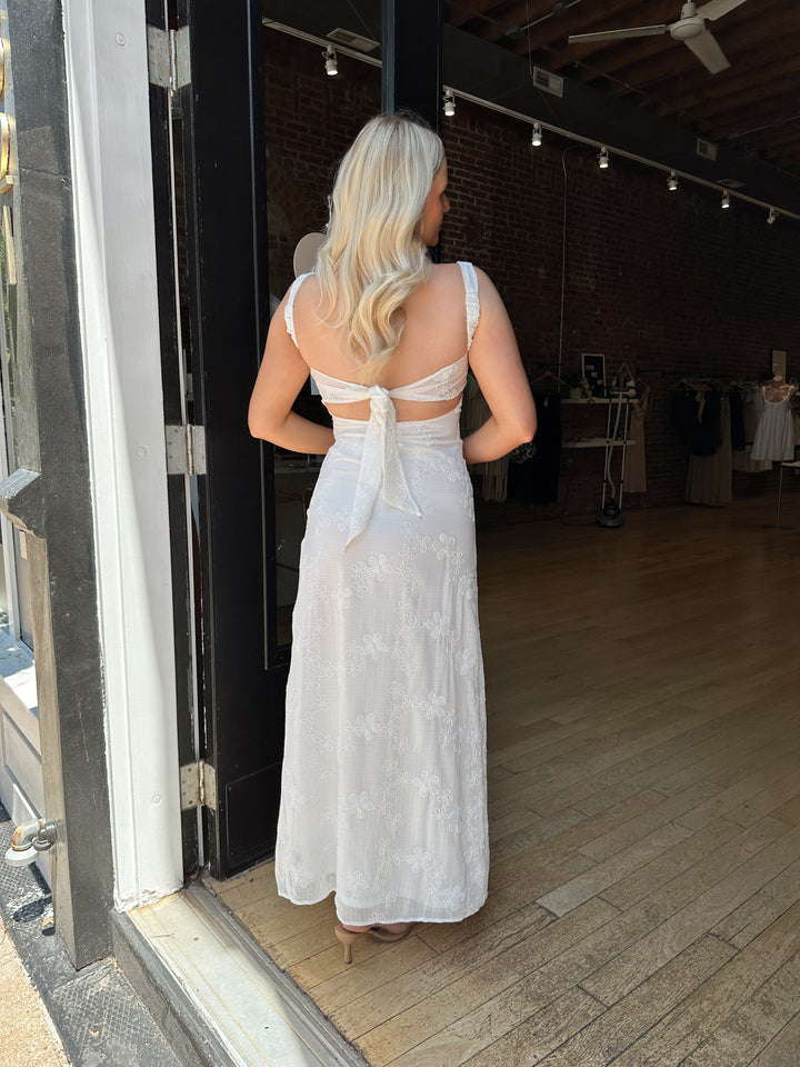 Woman white maxi dress with embroidery detailing and open tie back. 