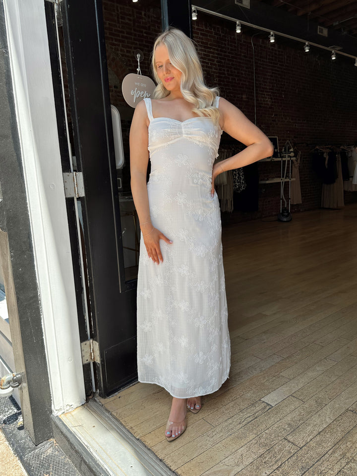 Woman white maxi dress with embroidery detailing and open tie back. 