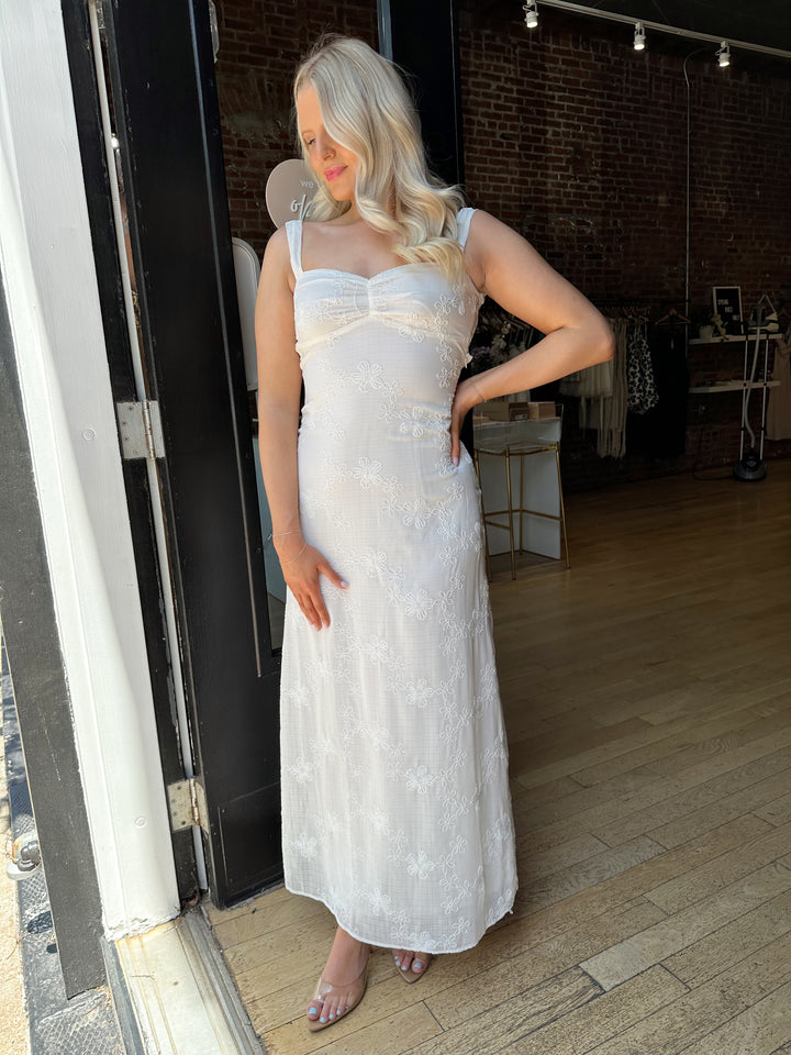 Woman white maxi dress with embroidery detailing and open tie back. 