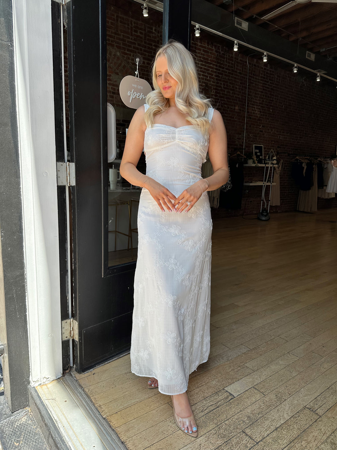 Woman white maxi dress with embroidery detailing and open tie back. 
