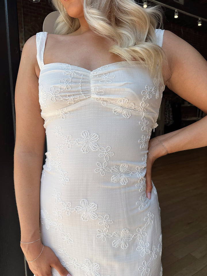 Woman white maxi dress with embroidery detailing and open tie back. 