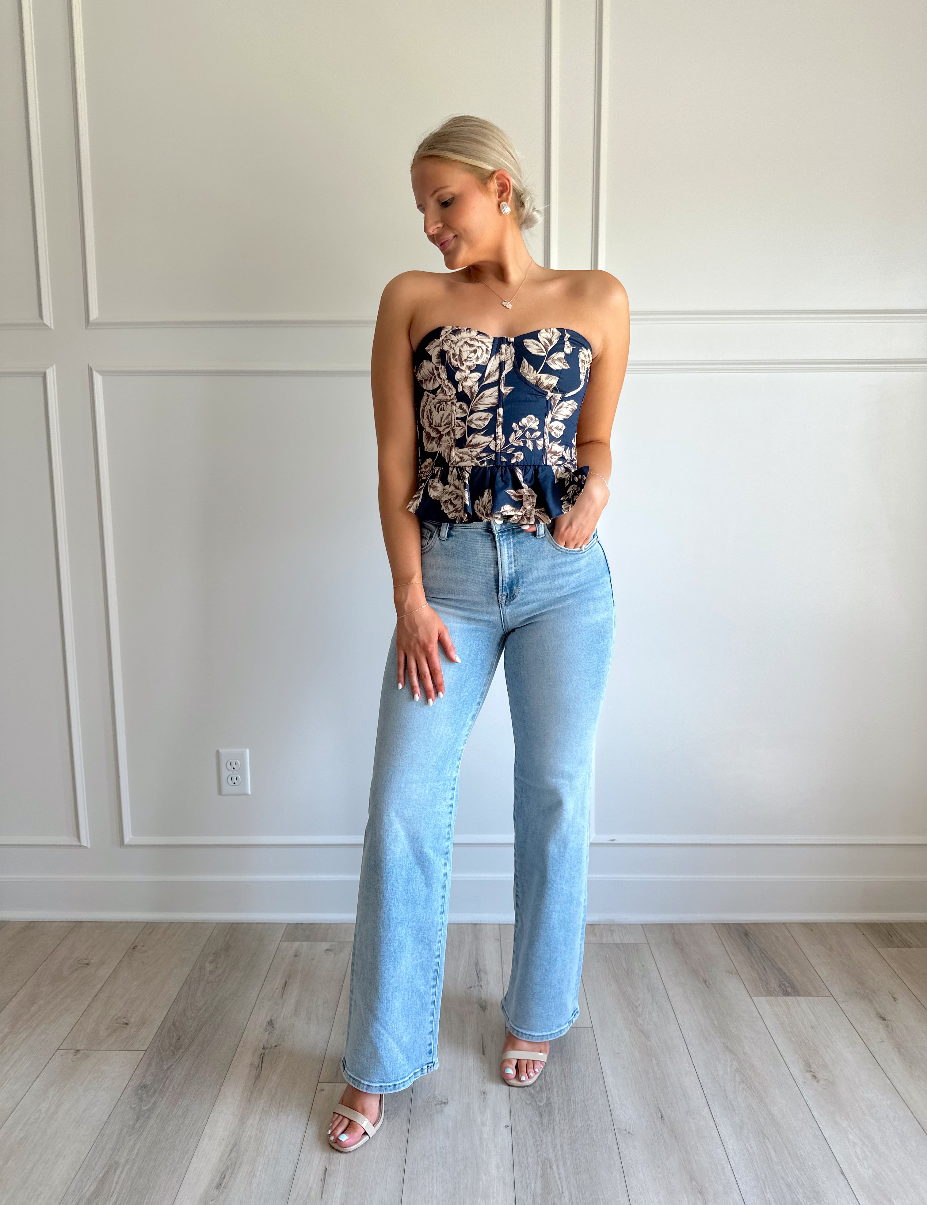Navy blue peplum corset top with brown floral pattern.
