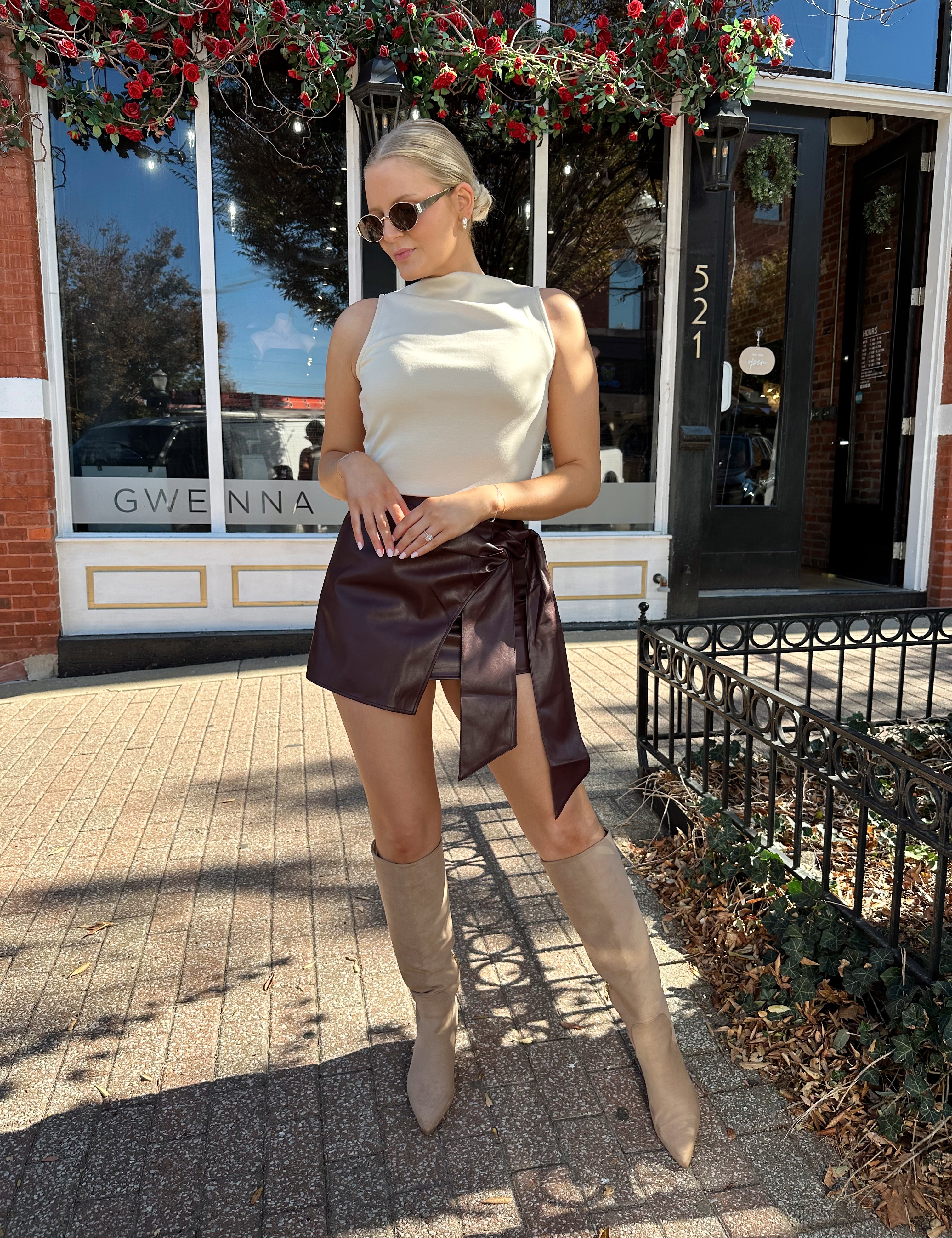 Woman wearing burgundy leather mini wrap skort. 