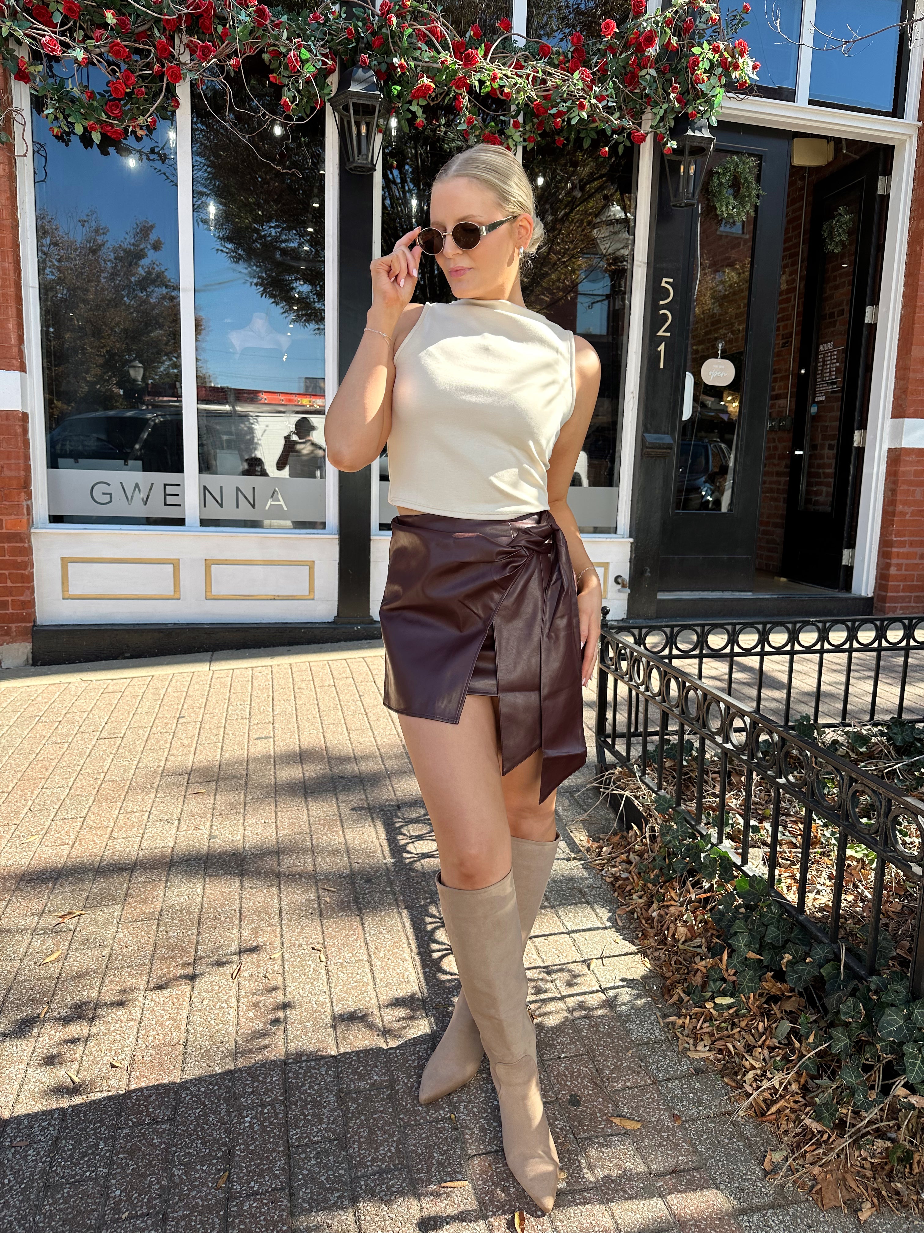 Woman wearing burgundy leather mini wrap skort. 