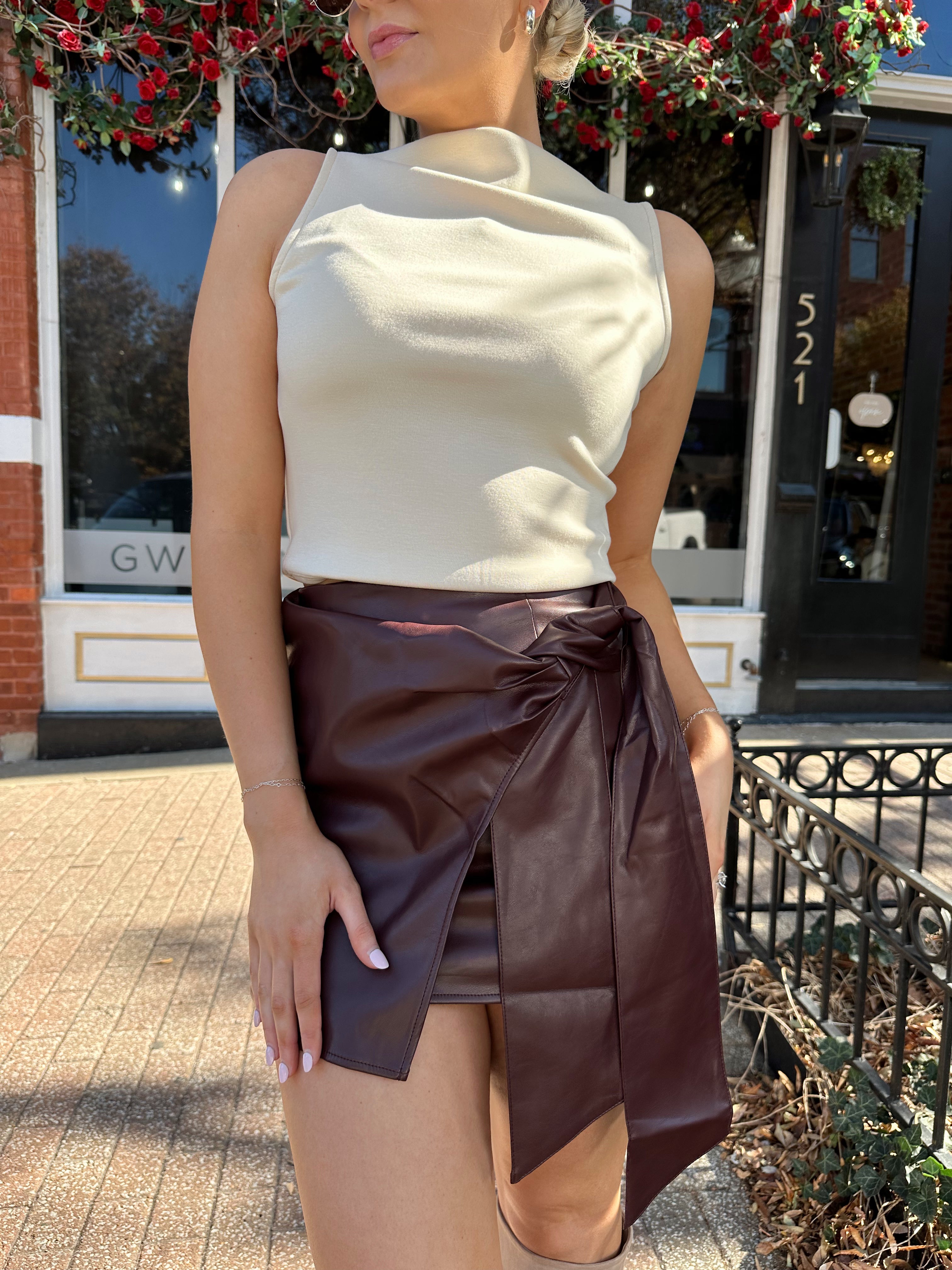 Woman wearing burgundy leather mini wrap skort. 
