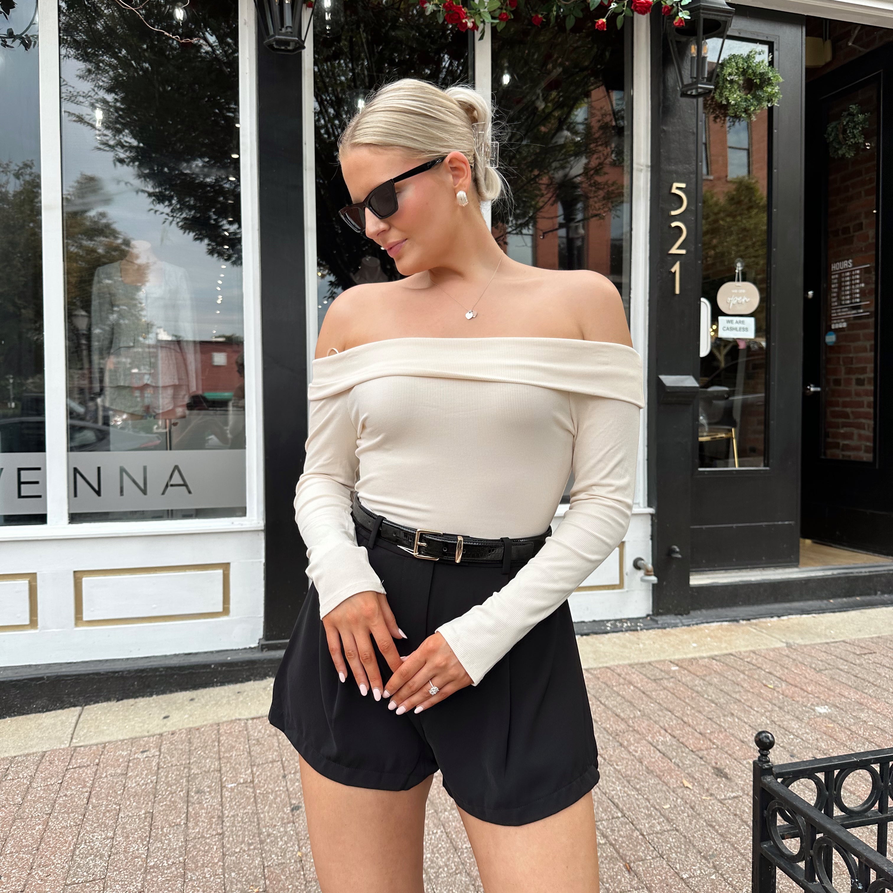 Cream colored ribbed long sleeve off the shoulder bodysuit. 