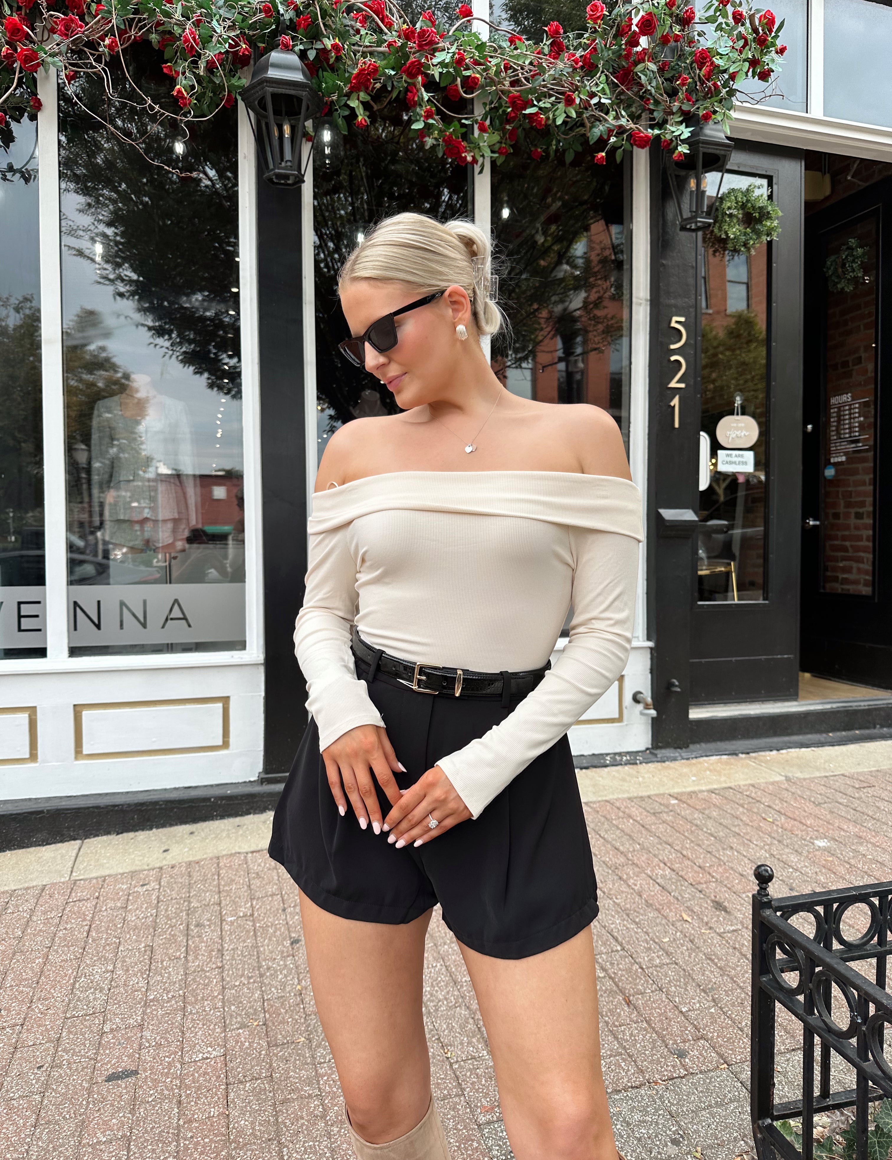 Cream colored ribbed long sleeve off the shoulder bodysuit. 